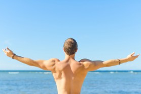 Muscular attractive man near the sea. Freedom concept. Muscular attractive man near the sea. Freedom concept.